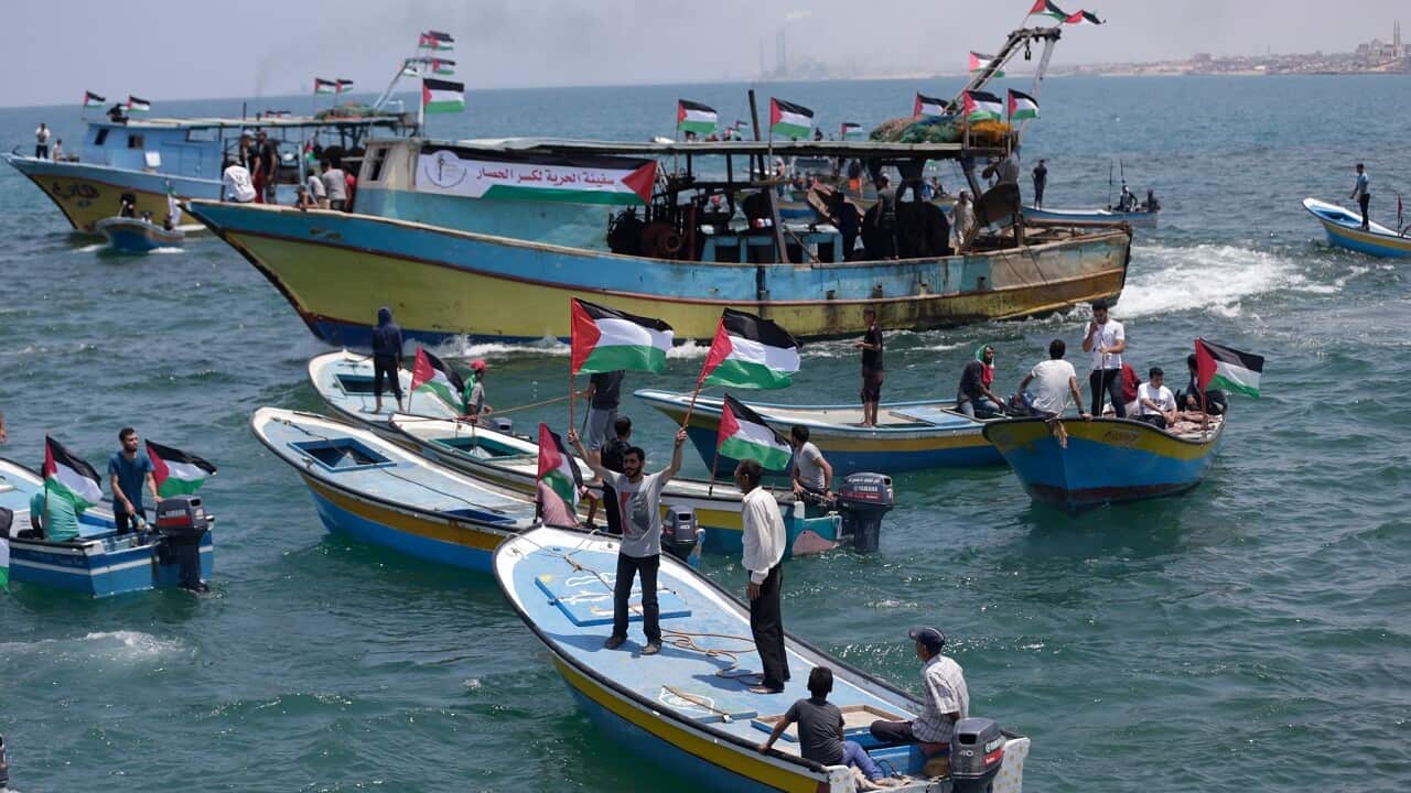 Fishing boats carrying a group of Palestinian activists set sail from Gaza City harbour.