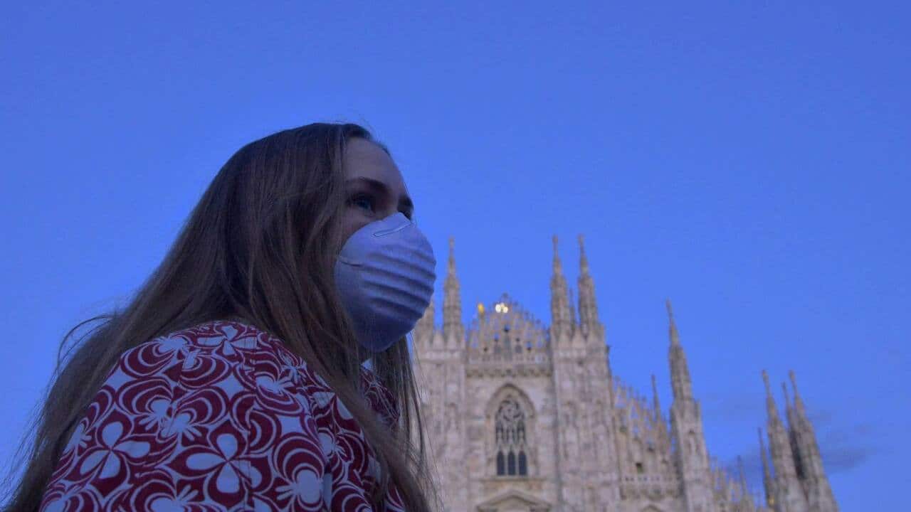 Family all wear face masks to avoid contagion from Covid19 in Piazza del Duomo.