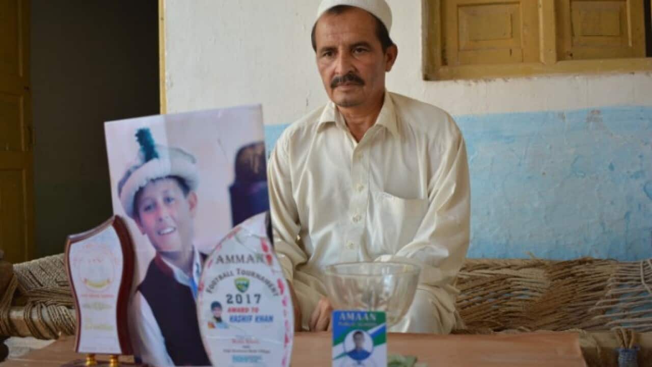 Father with his deceased son's photo
