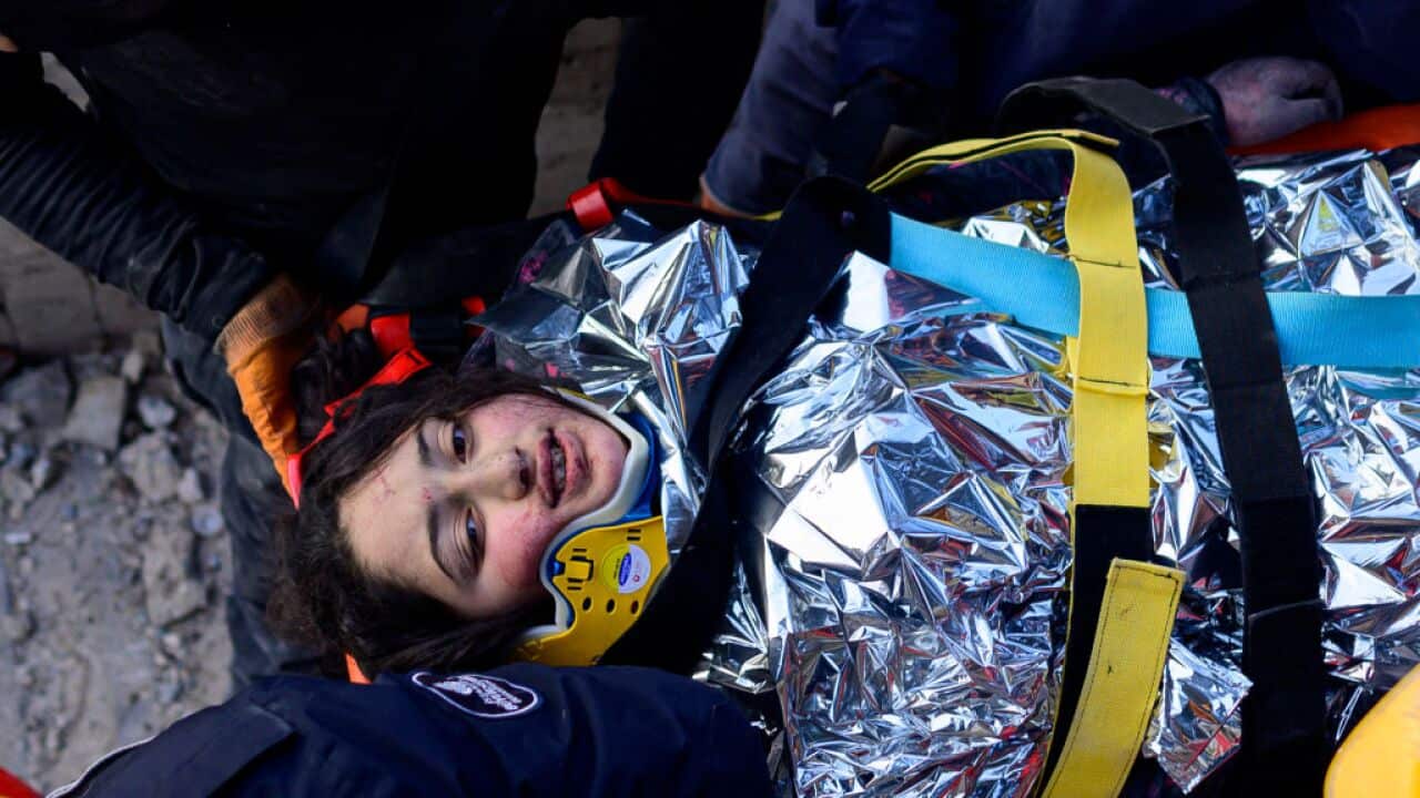 A 12-year-old Syrian girl, Cudi, is evacuated by rescuers from the rubble of a destroyed building in Hatay, Türkiye.