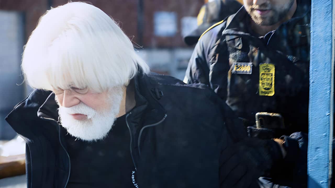 Paul Watson is arrested in Greenland and escorted to a police vehicle (AAP).png