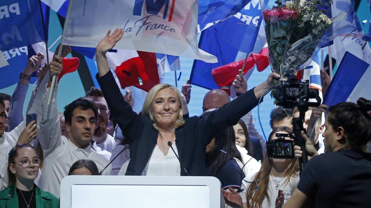 French far-right leader and candidate for the 2022 presidential election Marine Le Pen is seen waving.