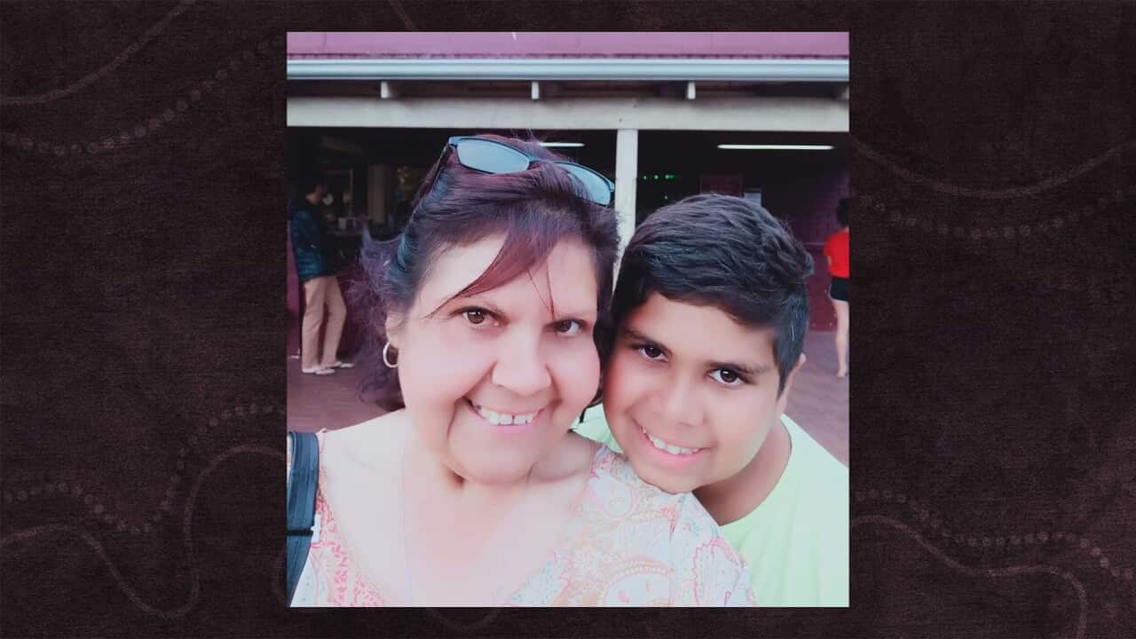 Cassius Turvey and his mother smile for a photo together