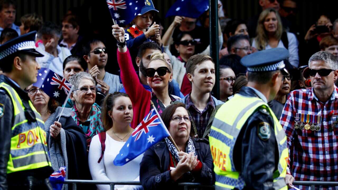 Crowds cheer during the Anzac Day parade in Sydney.