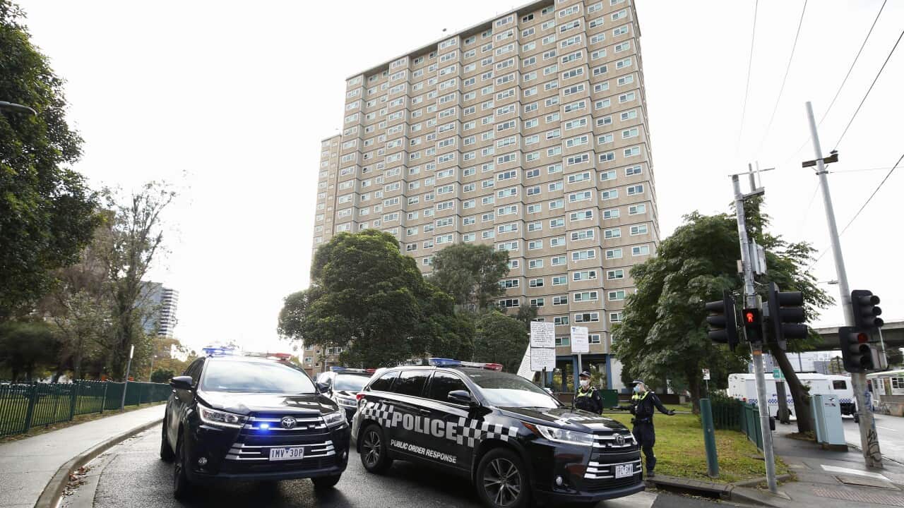 Police patrols are seen outside public housing towers on Racecourse Road in Flemington.