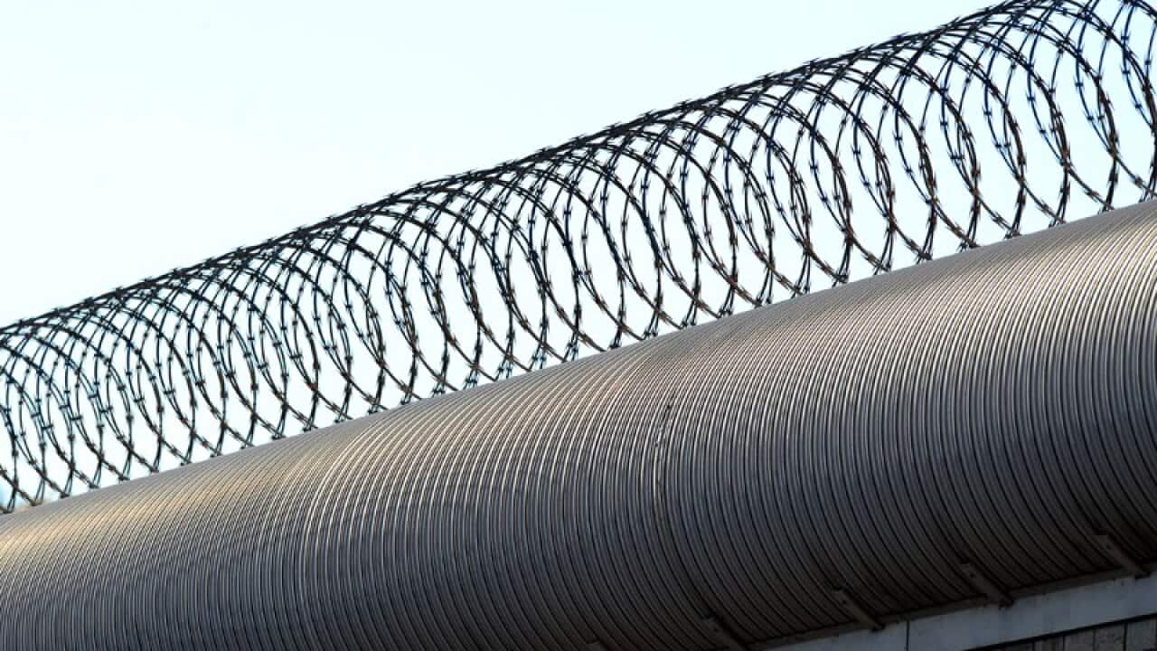 A riot involving 21 inmates has left two people injured at the Darwin Correctional Centre.