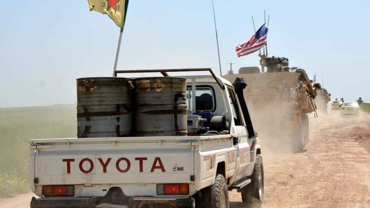 A convoy of YPG and US trucks