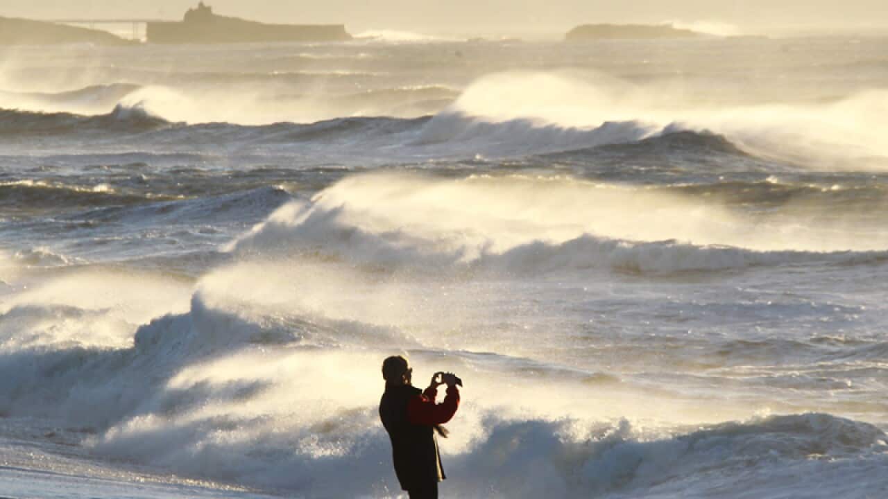A person takes pictures of big waves in the Atlantic Ocean