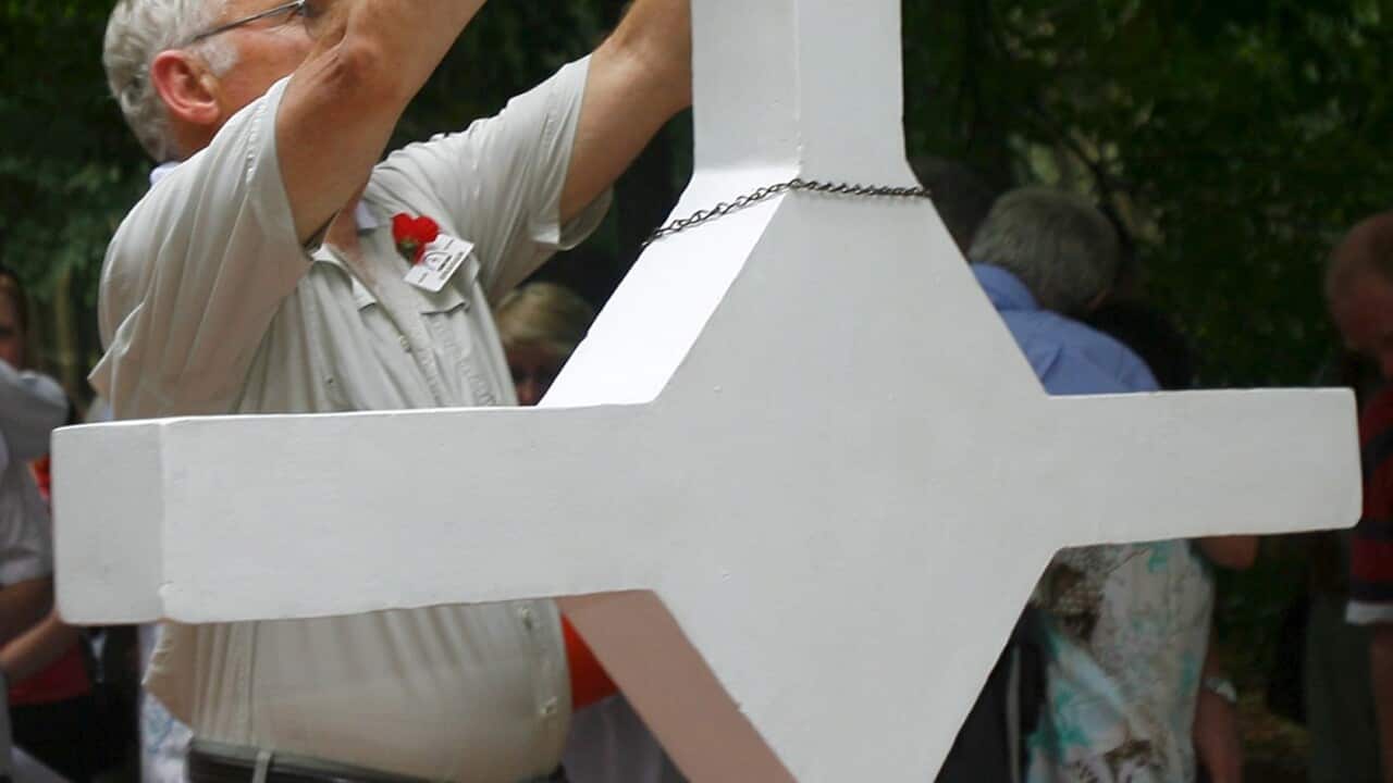 An Australian Veteranput his hat on the cross of the Long Tan Battle at Vung Tau province, Vietnam, Friday 18 August 2006. 