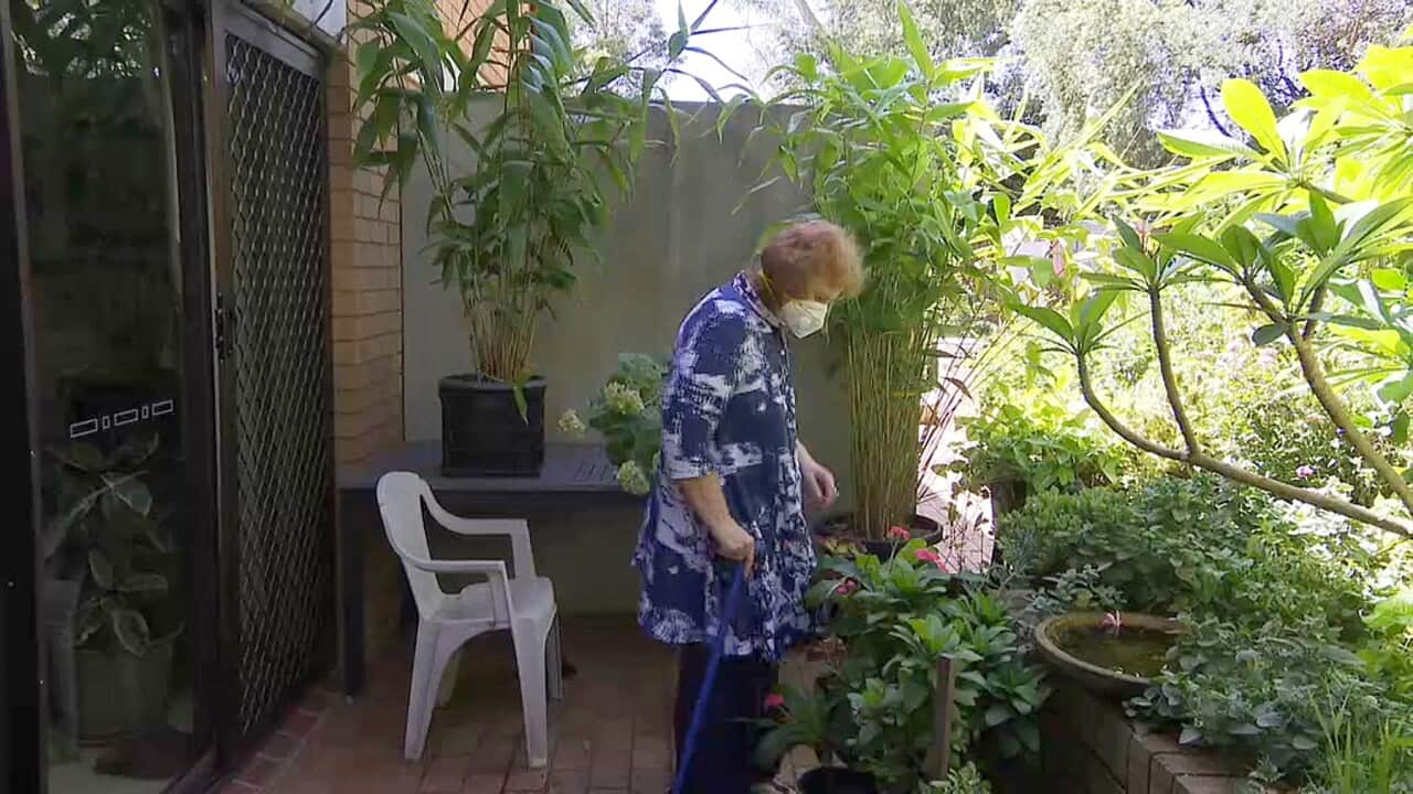 Marion Rae with face mask in her garden