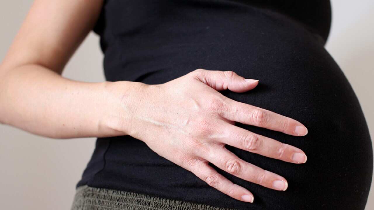 A woman eight months into her pregnancy