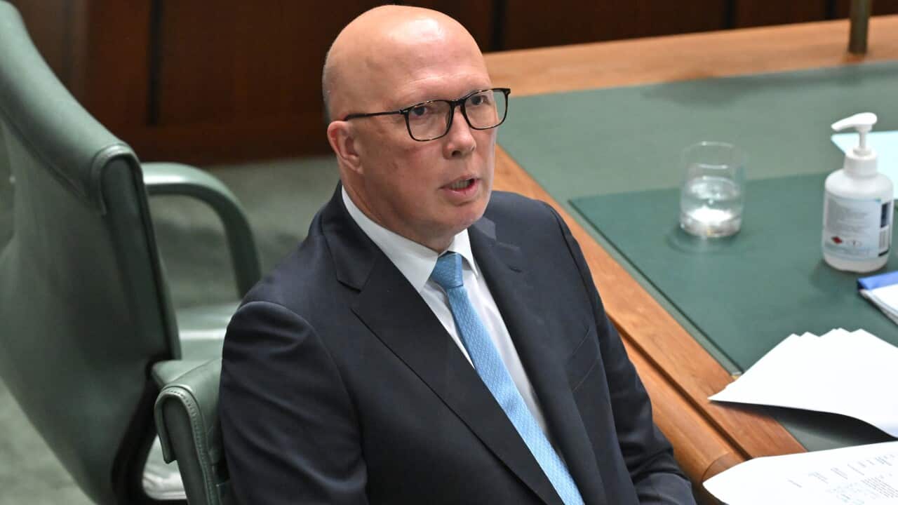 A man sits in a chair in parliament.
