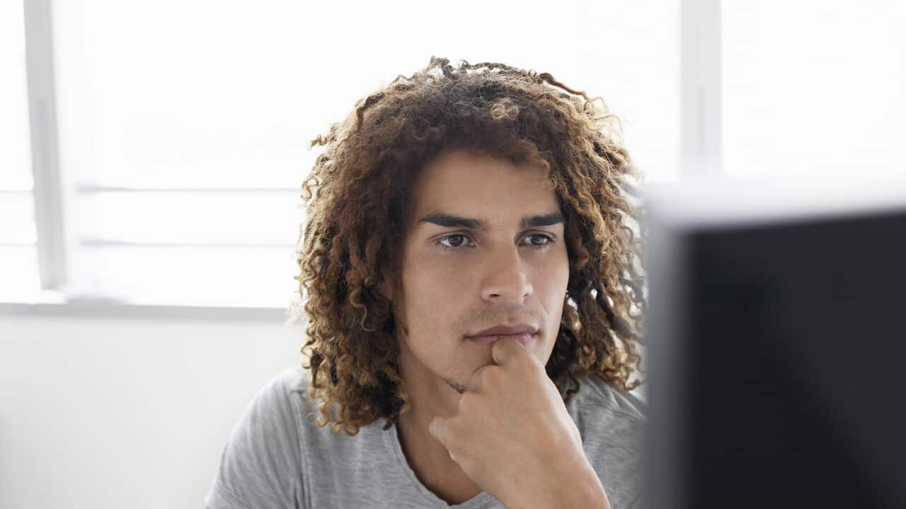 Young man in t-shirt using computer