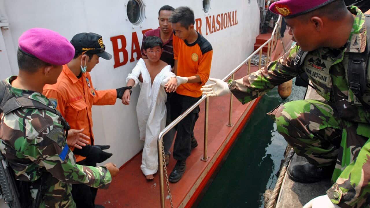 Indonesian rescuers evacuate an asylum-seeker survivor