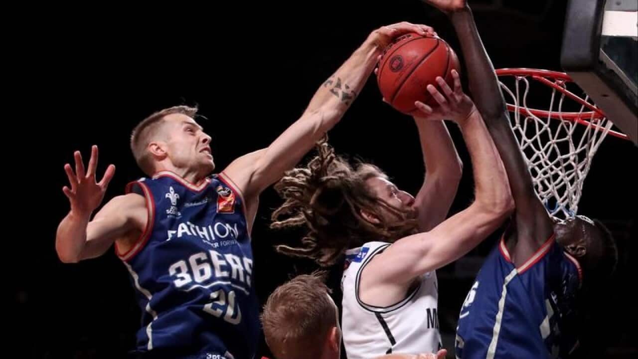 Adelaide 36ers Nathan Sobey blocks Craig Moller of Melbourne United.