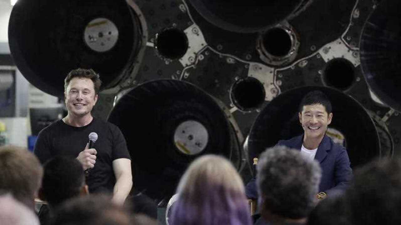 SpaceX founder and chief executive Elon Musk, left, speaks after announcing Japanese billionaire Yusaku Maezawa, right, as the first private passenger on a trip around the moon, Monday, Sept. 17, 2018.