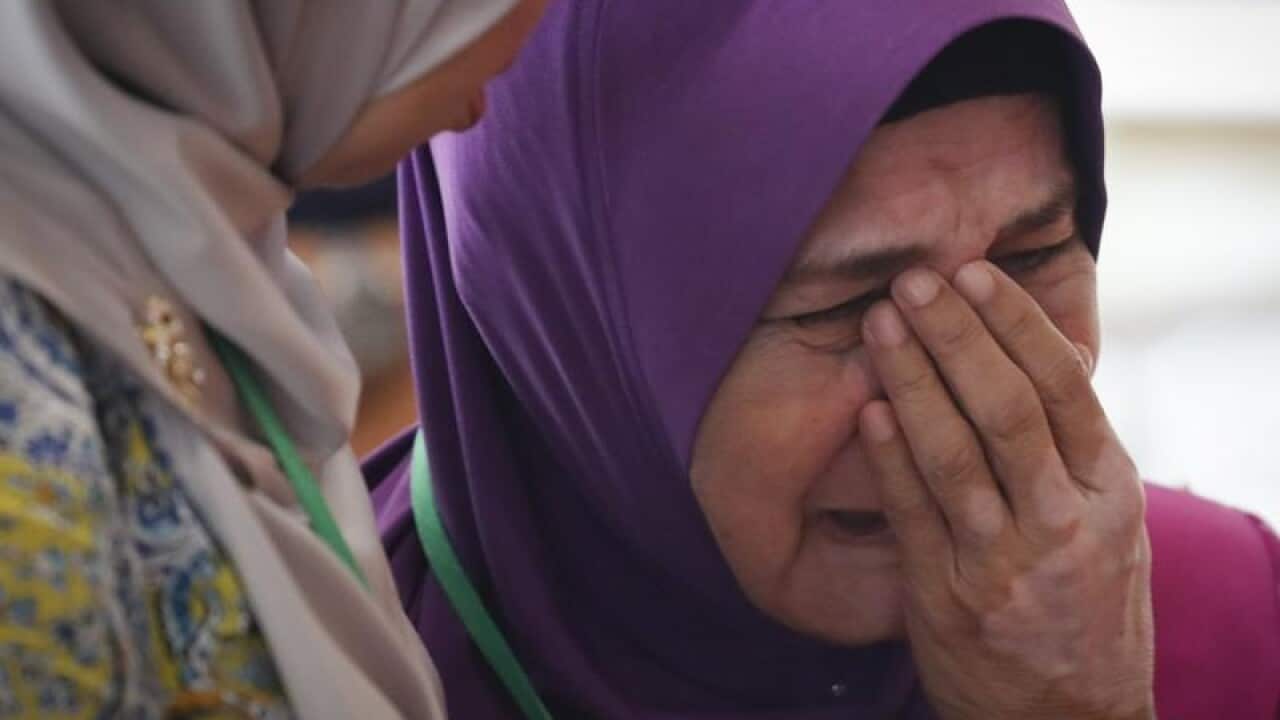 Mother of MH370 passenger cries after briefing