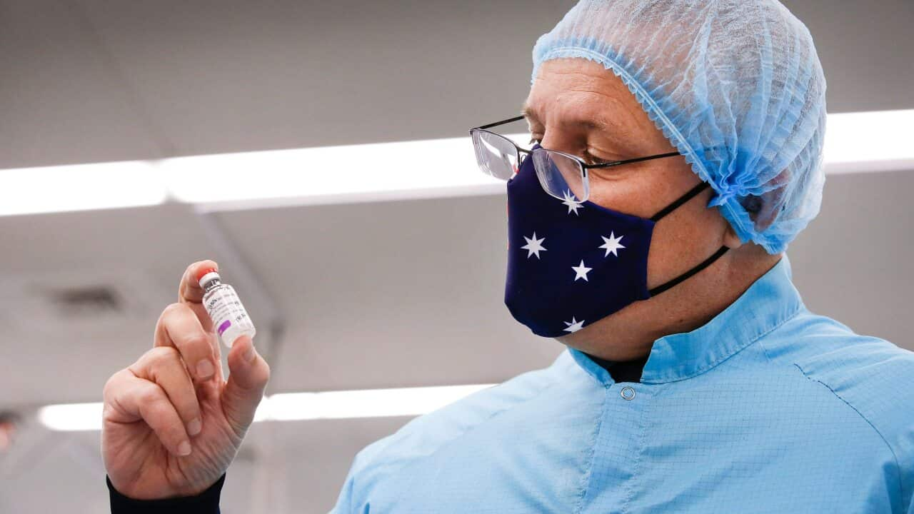 Prime Minister Scott Morrison holds a vial of AstraZeneca vaccine during a visit to the CSL serum lab to inspect COVID-19 Immunoglobulin being produced in Parkville, Melbourne, Friday February 12, 2021.