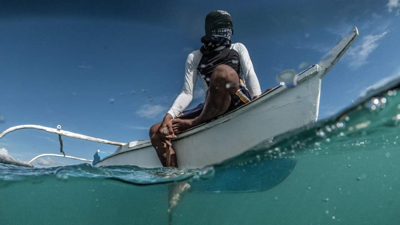 A dynamite fisherman scans the waters off the coast of Bohol, the Philippines, April 11, 2018.