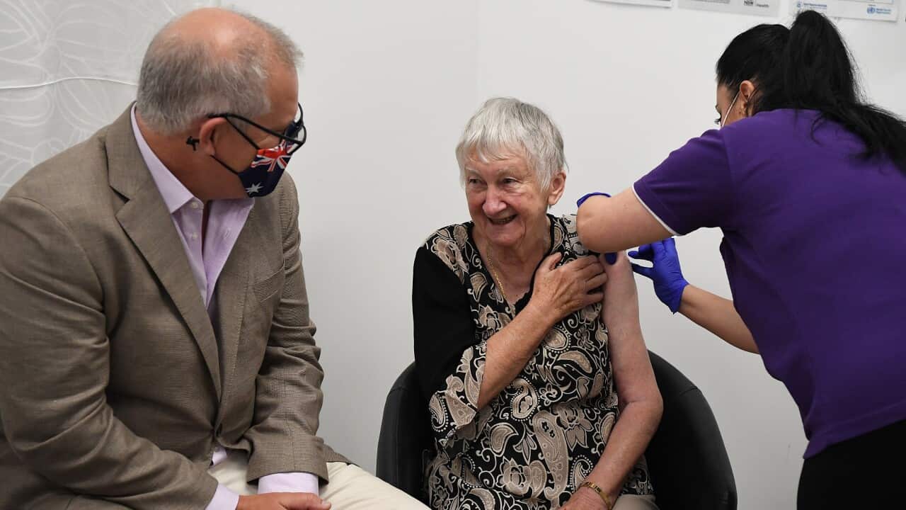 Australian Prime Minister Scott Morrison joins aged care resident Jane Malysiak (left) as she receives the first COVID-19 vaccine in Australia