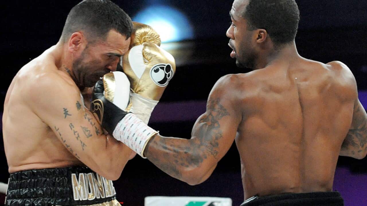 Anthony Mundine (left) clashes with Charles Hatley of the USA