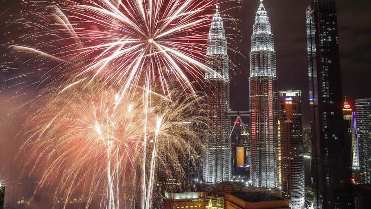 Fireworks illuminate the night sky over Malaysia's Petronas Towers