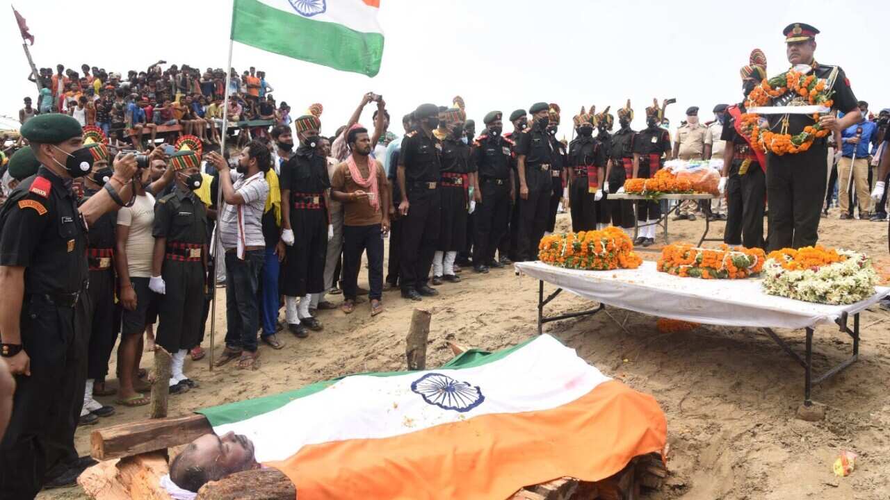Major General Rajpal Punia pays tribute to Havildar Sunil Kumar before his last rites are performed at Maner on June 18, 2020 near Patna, India. Hav. Sunil Kumar was among the twenty Indian army personnel martyred in a clash with Chinese troops in Ladakh’
