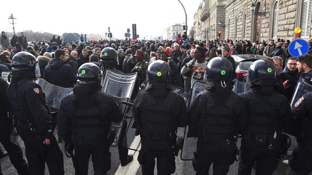Senegalese demonstrators face police during a demonstration at Vespucci bridge in Florence, Tuesday, March 6, 2018. 
