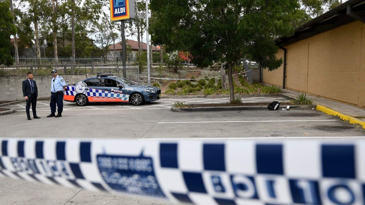 NSW police are seen near a backpack and knives at a shopping centre adjacent to Bonnyrigg high school, west of Sydney, Thursday, Feb. 2, 2017.