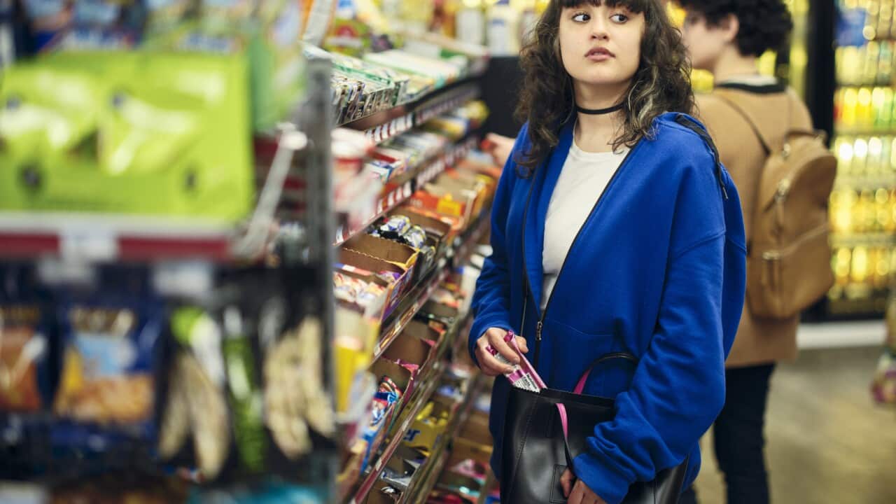 Young Woman Shoplifting in a Convenience Store