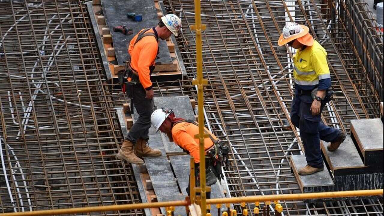Construction workers are seen on a building site.