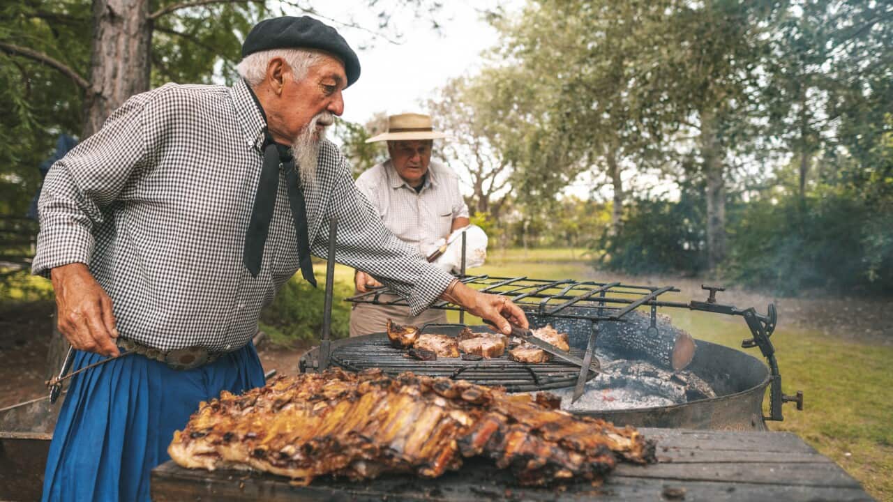 Men preparing a rib barbecue in the firewood
