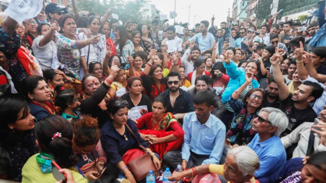 Murder victim Nirmala Panta's parents sit with protesters in Kathmandu on Saturday 16 Sept 18.