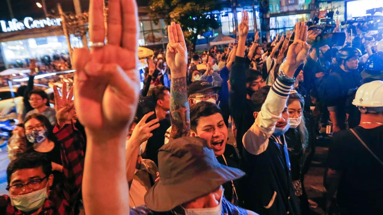 Protesters raise a three-finger salute during a demonstration outside the German embassy in Bangkok, 17 Oct 2020