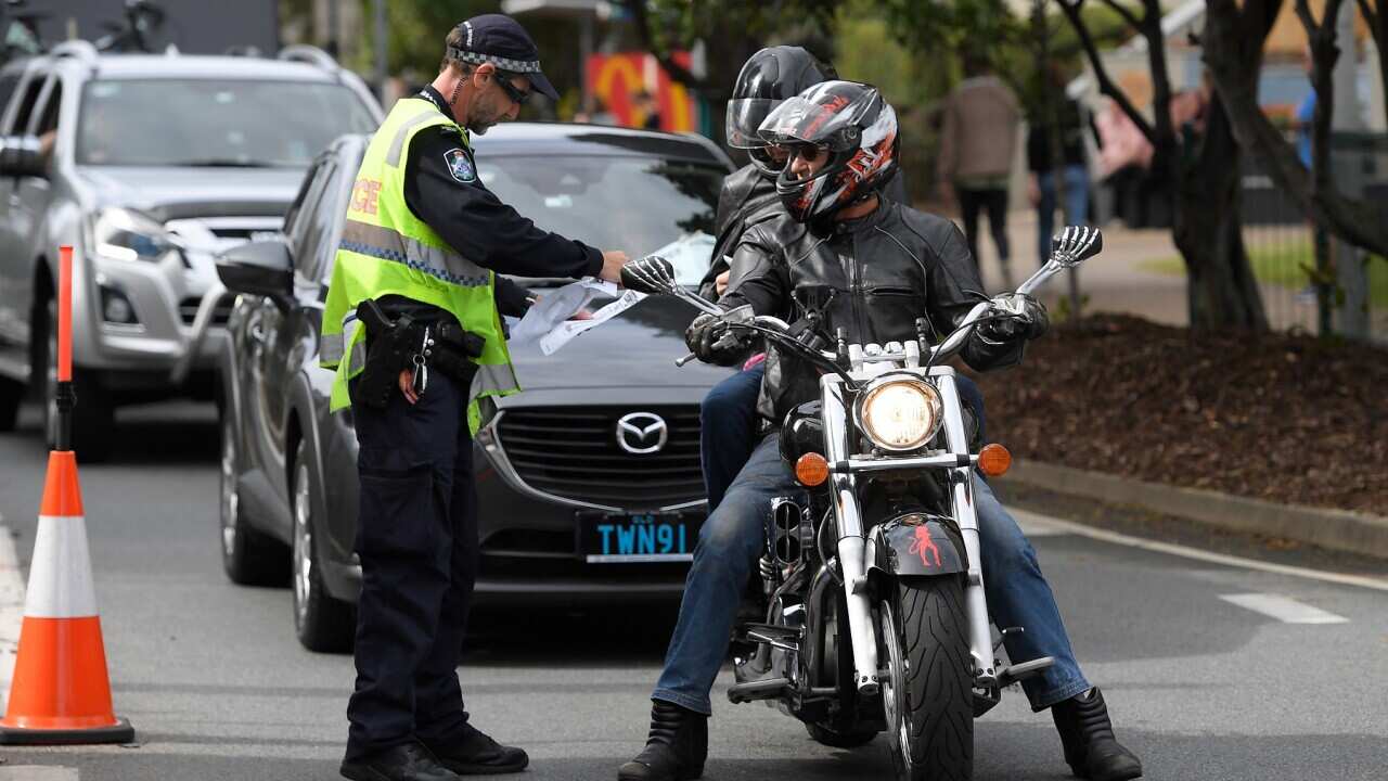 Police stop motorists crossing the Qld-NSW border to check to for permits