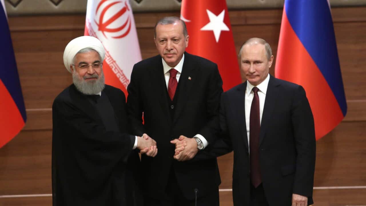 Iran's President Hassan Rouhani, left, Russia's President Vladimir Putin, right, and Turkey's President Recep Tayyip Erdogan