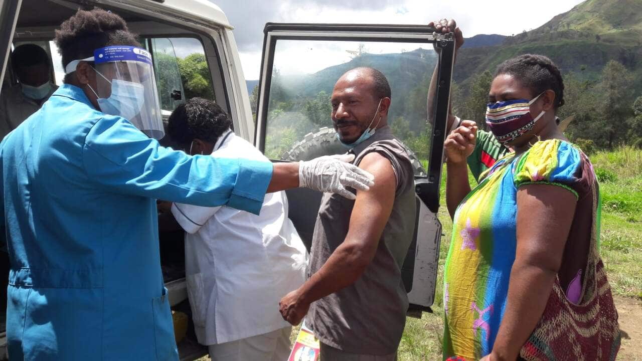 A man in Papua New Guinea gets vaccinated.