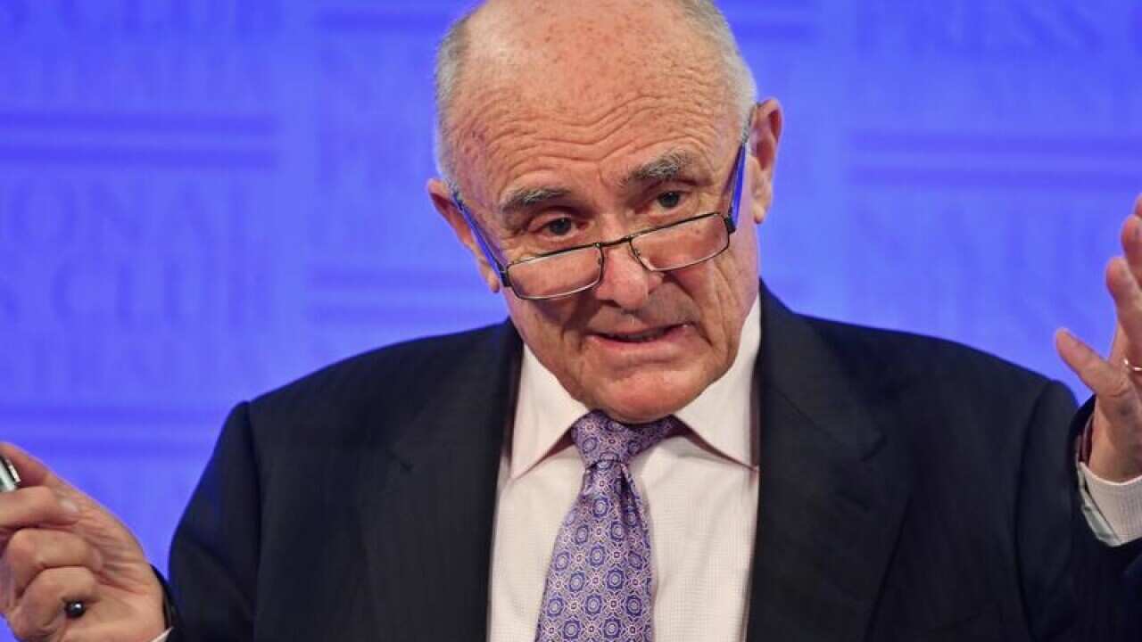 Allan Fels holds his hands up.