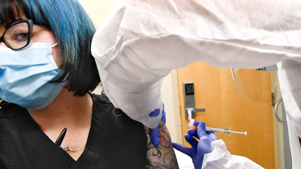 A Moderna vaccine trial participant receiving the injection of a possible COVID-19 vaccine in July, 2020.