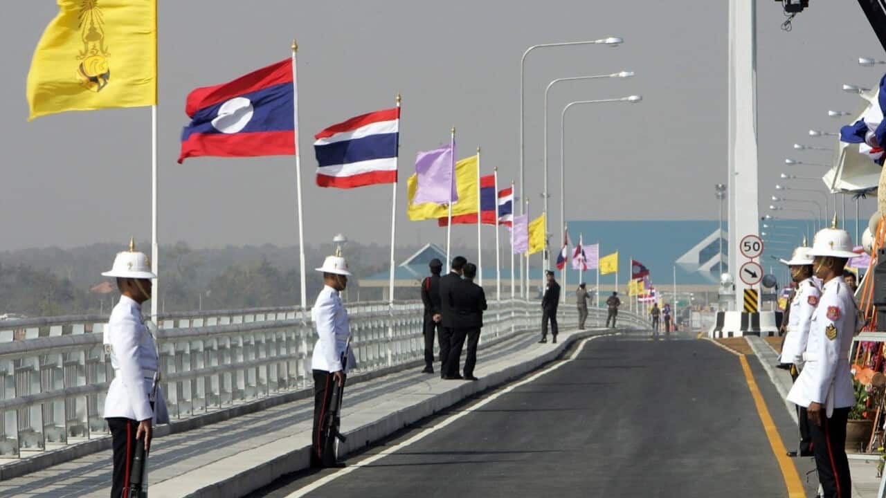 Lao and Thai flags on the first Lao-Thai bridge over the Mekong River (PORNCHAI KITTIWONGSAKUL - AFP via Getty Images)