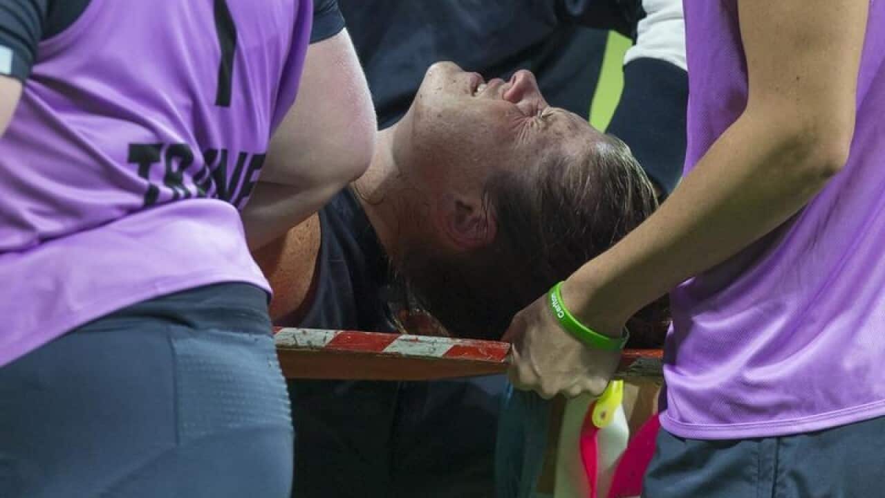 Brianna Davey of the Blues is injured and carried from the field.