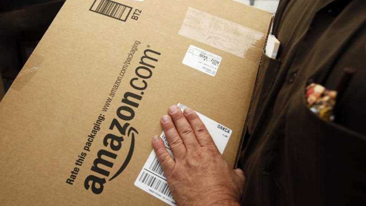In this Oct. 18, 2010 file photo, an Amazon.com package is prepared for shipment by a United Parcel Service driver.