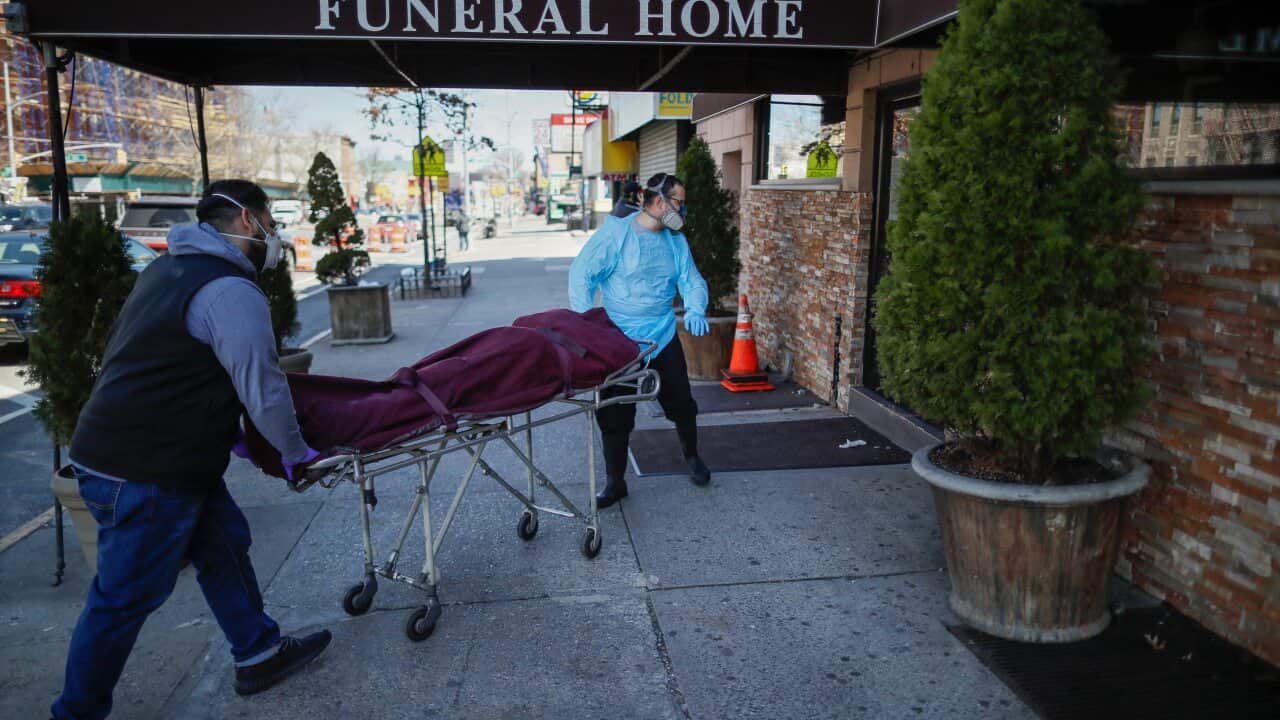 Employees deliver a body at Daniel J. Schaefer Funeral Home, Thursday, April 2, 2020, in the Brooklyn borough of New York.