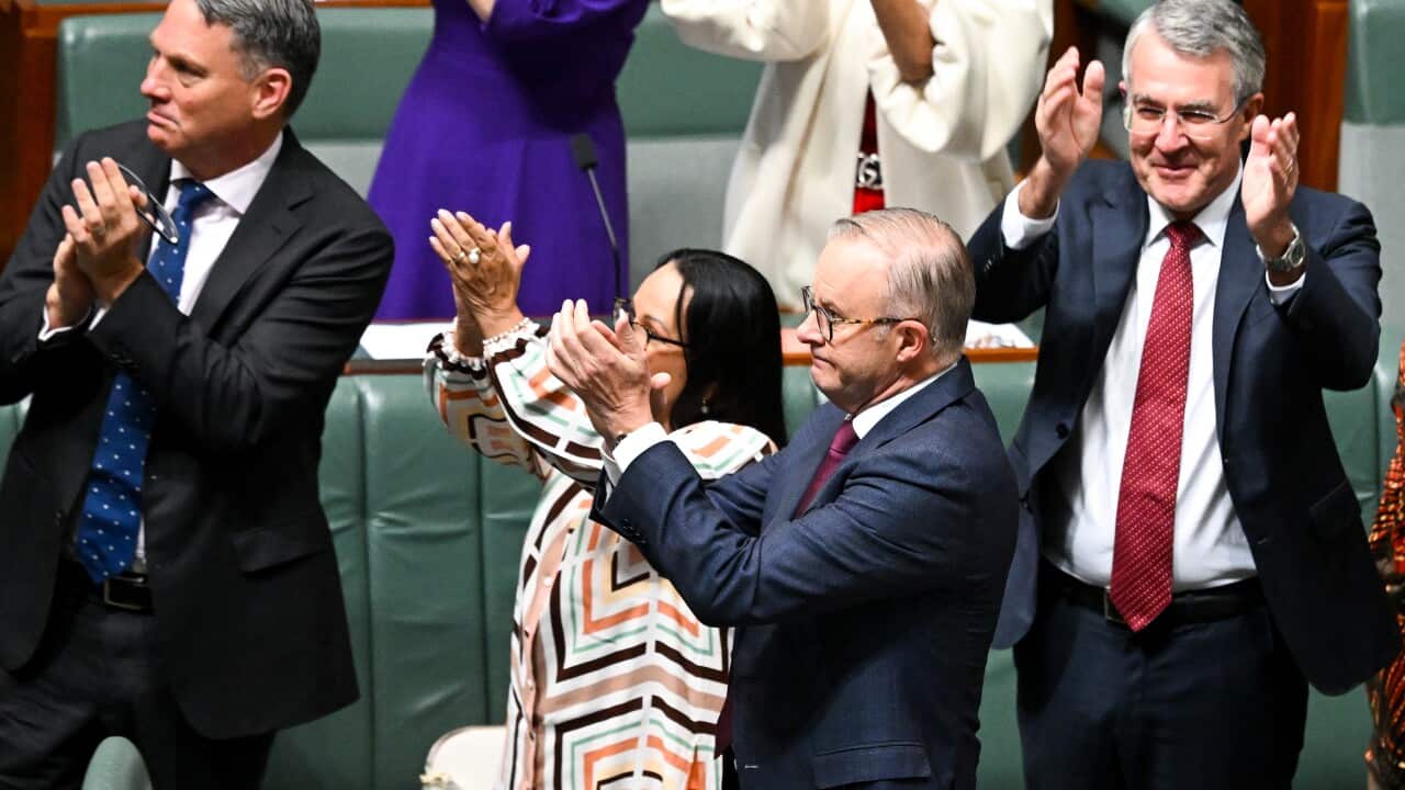 People clap at the Parliament House