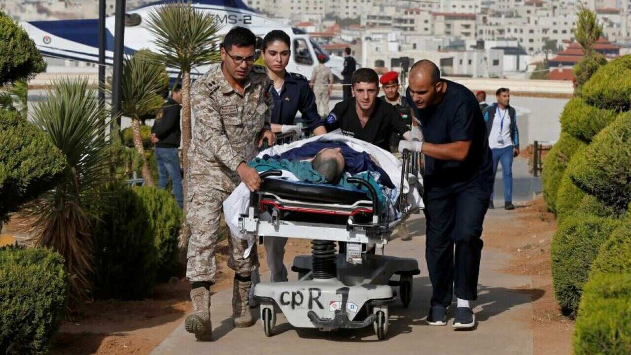 Emergency services rush an injured tourist to the King Hussein Medical Centre in Amman after the attack.