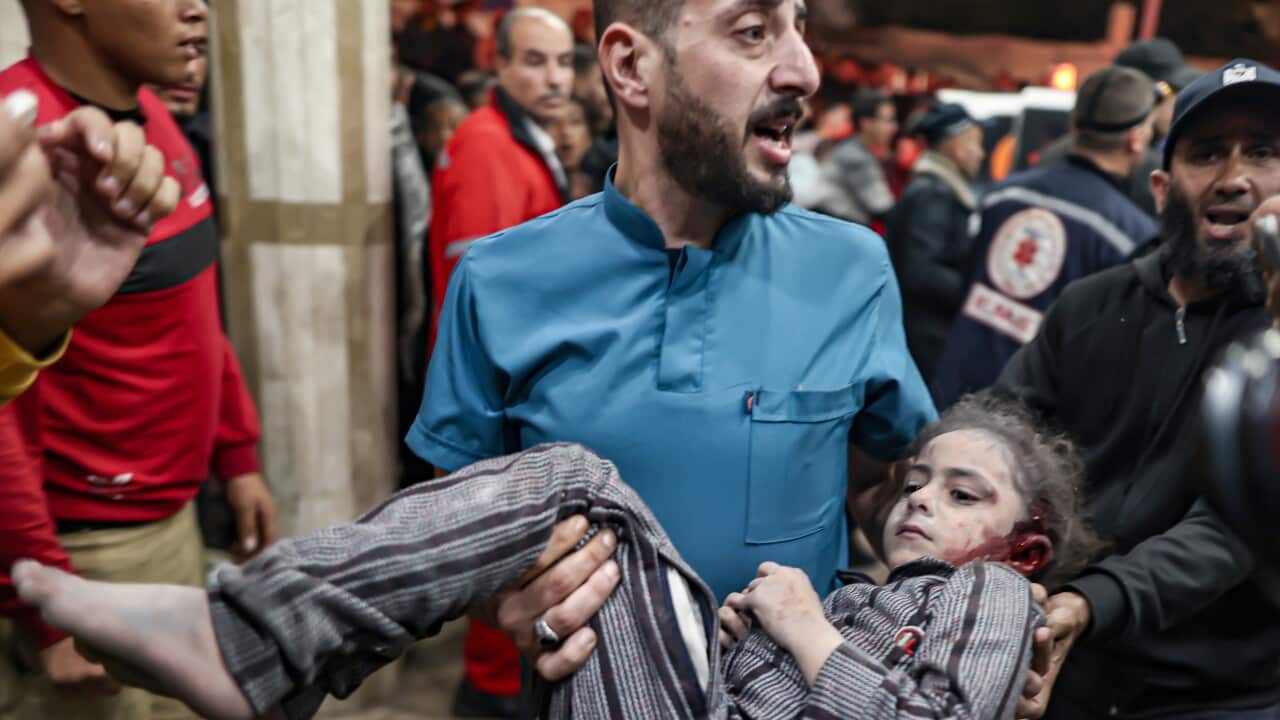 A man carrying an injured child