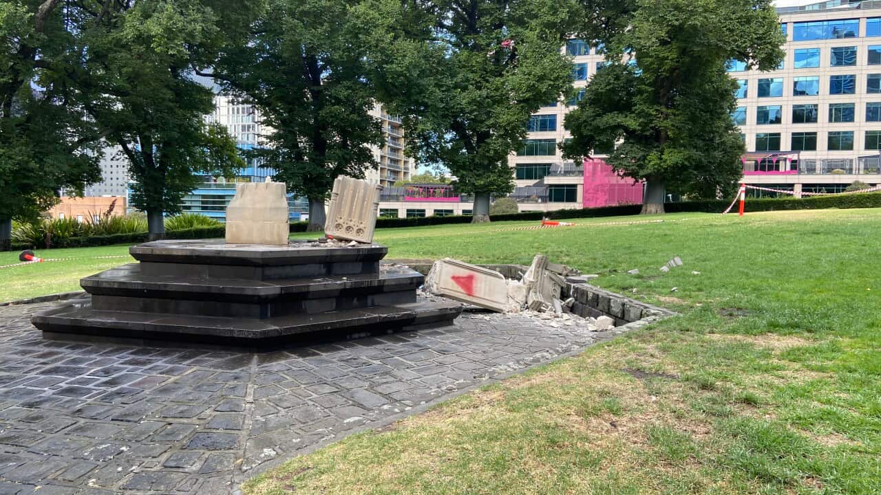 Broken stone work next to a plinth in a park
