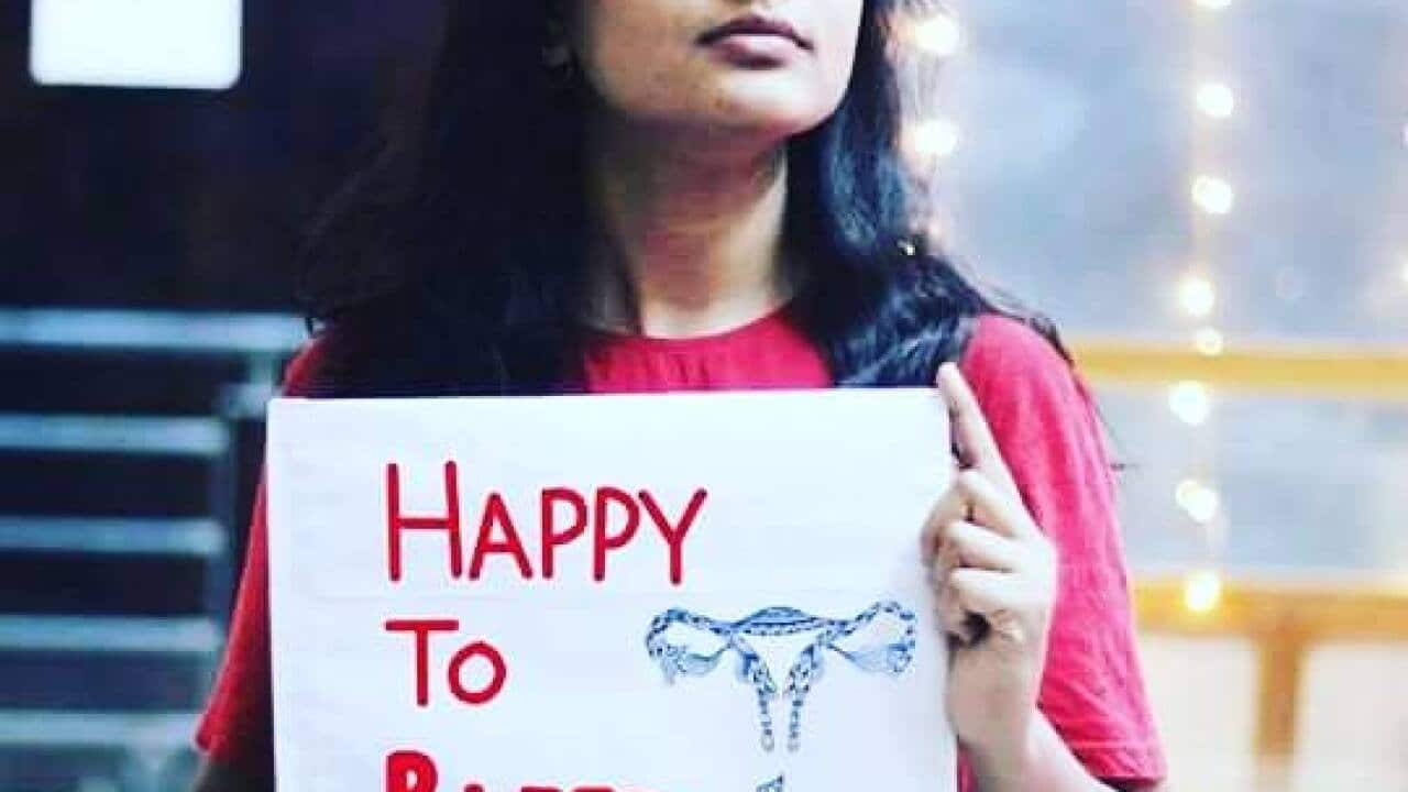 A woman takes part in the #HappyToBleed campaign.