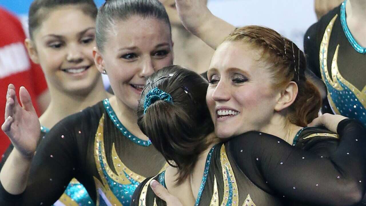 Members of team Australia react during the women's team final