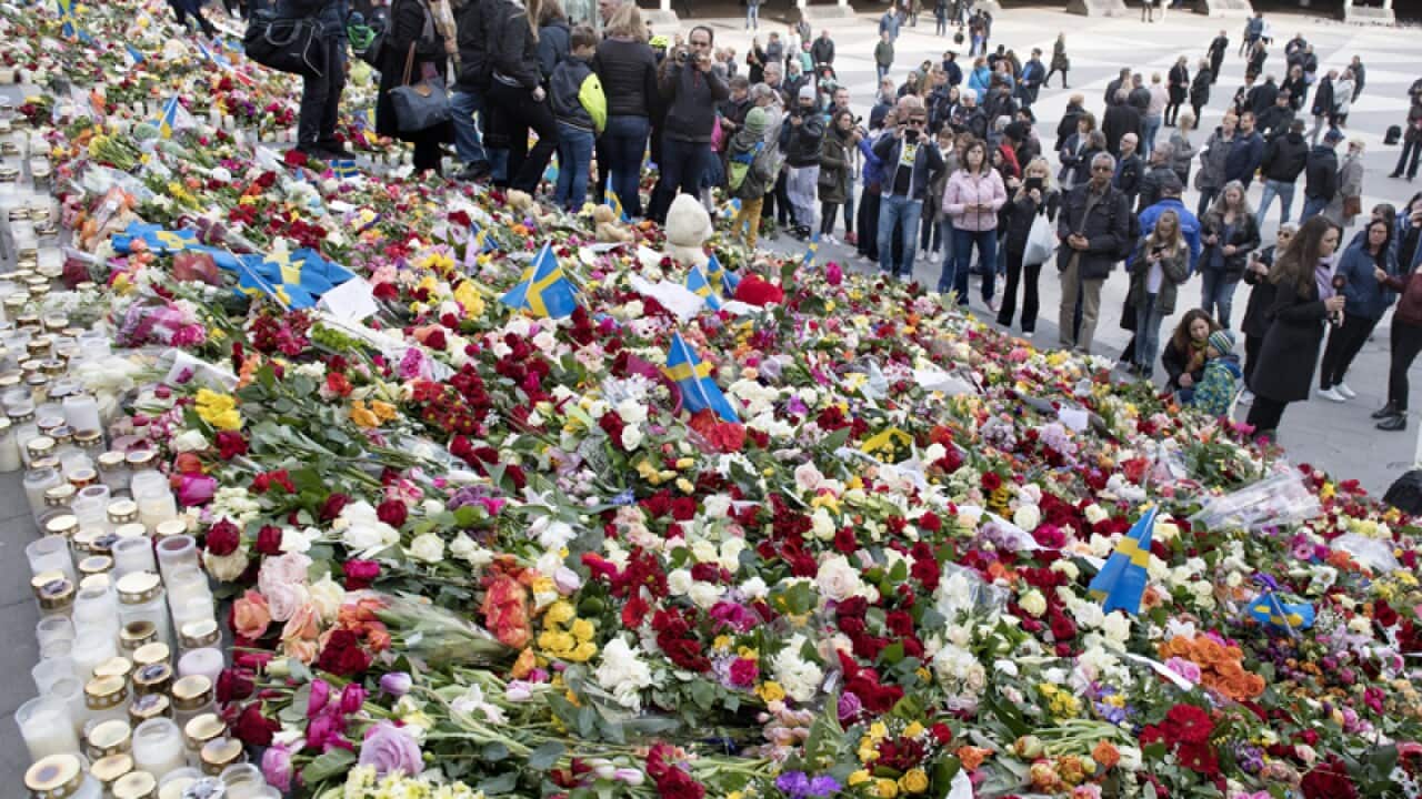 People leave floral tributes at Sergels Torg public square
